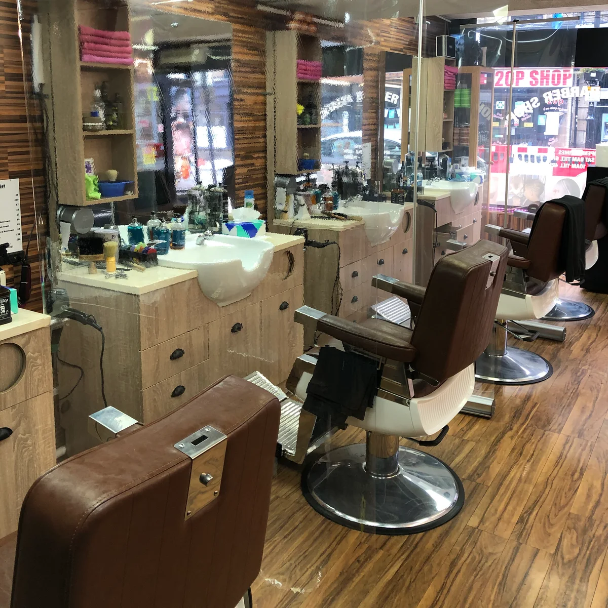Brown leather barber chairs and mirrors inside Antalya Barber Shop
